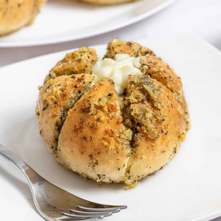 Korean cream cheese garlic bread pulled open to show the filling