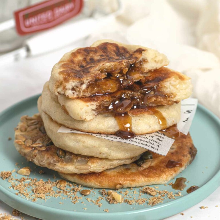 A stack of golden brown Korean sweet pancakes, hotteok