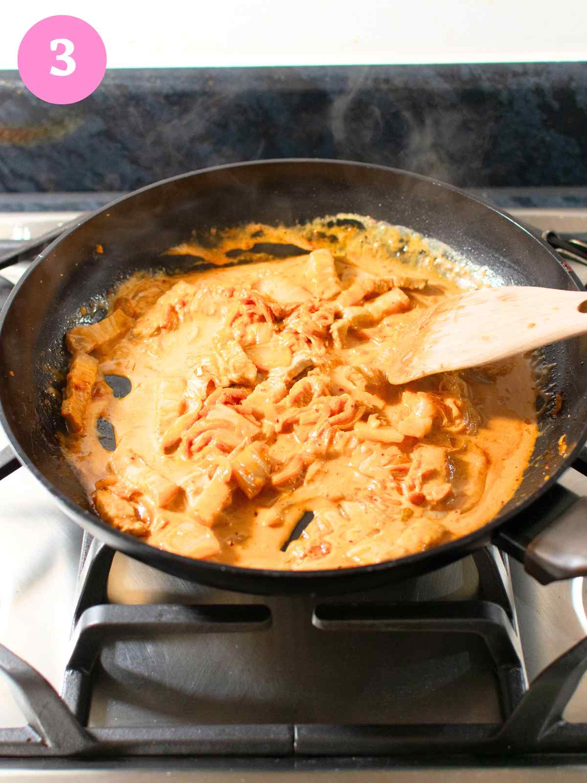 Creamy orange sauce with kimchi in black pan
