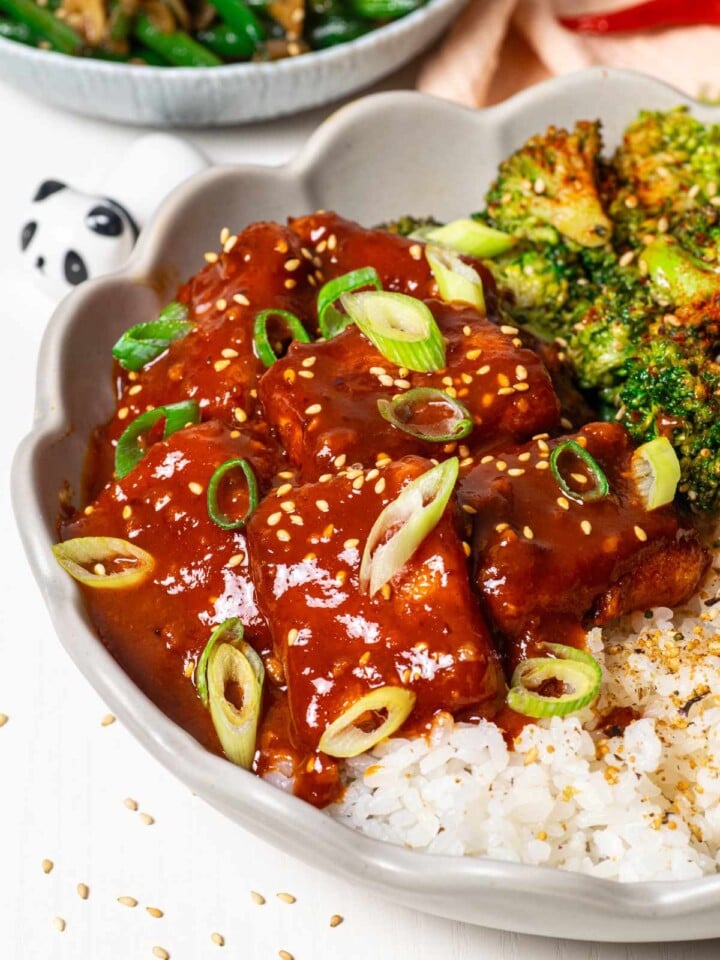 Gochujang tofu in sauce on rice with broccoli on the side